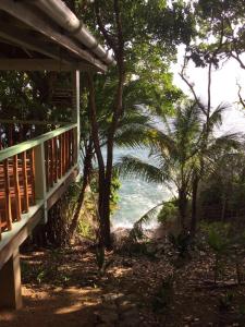a view of the ocean from the porch of a house at Beautiful Cottage overlooking Sea in Goodwood