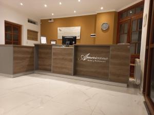 a lobby with a reception desk in a building at Hotel Americano in Perito Moreno
