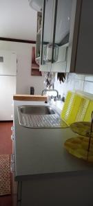 a kitchen with a sink and a counter top at Sunclass Tignale Bungalow Gardasee in Tignale +6 photos