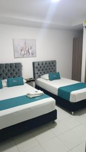 two beds sitting next to each other in a room at House Concepcion in Estación El Salto