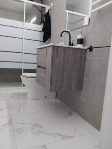 a bathroom with a sink and a toilet in it at CASA ADELA - Playa 2 min - Aire Acondicionado - WIFI - Parking cercano in Barbate