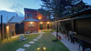 a backyard of a house with a lawn and a house at ARWEN Suites 1 in Trevelín