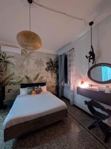 a bedroom with a large bed and a mirror at Janua Jungle House in Genoa