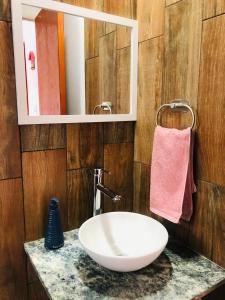 a bathroom with a white sink and a mirror at Departamentos Los Robles 1 in Comodoro Rivadavia