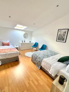 a bedroom with two beds and a desk at Grande Maison XXL in Villiers-le-Bel +54 photos