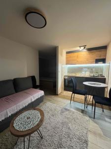 a living room with a couch and a table at Arni apartments in Donja Vrežina