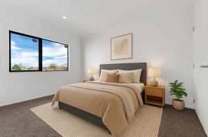 a bedroom with a large bed and a window at Unique Stays in Auckland