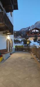 a building with a patio with a view of a river at Bella Cortina - comodo al centro e impianti, con garage in Cortina dʼAmpezzo
