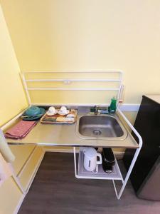 a sink in a small room with a table at Rivermount Motel in Little Fort +75 photos