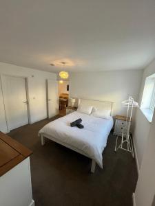 a bedroom with a white bed in a room at An Treth in Bude