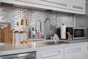 a kitchen counter with a sink and a microwave at Bright lights central Downtown in Los Angeles +19 photos