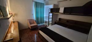 a bedroom with a bunk bed and a chair at Residencia G in Champotón