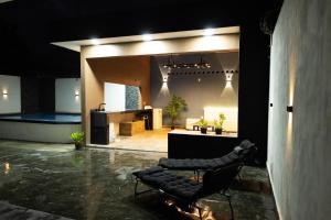 a room with two black chairs and a pool at Residencia G in Champotón