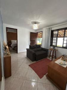 a living room with a couch and a table at Recanto da barra in Ilha do Bom Jardim