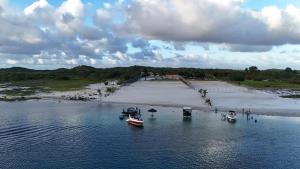 a group of boats in the water near a beach at Lagoa do Bonfim RN in Natal +26 photos