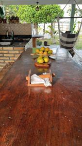 a wooden table with a bunch of fruit on it at Lagoa do Bonfim RN in Natal