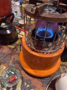 a wooden stove with a fire in it on a table at RUM LOREN lUXURY CAMP in Wadi Rum
