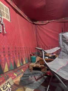 a chair in front of a red tent at RUM LOREN lUXURY CAMP in Wadi Rum