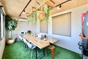 a conference room with a long table and chairs at NikkaHotel東郷店 in Togo