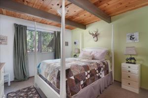 a bedroom with a bed and a wooden ceiling at Cozy Cabin - Hot Tub, Fire Pit, & Pets in Arnold +79 photos