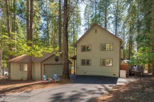 a small house in the middle of a forest at Cozy Cabin - Hot Tub, Fire Pit, & Pets in Arnold