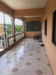 an empty room with a tiled floor and windows at Sky Studio Oasis in Montego Bay