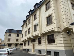 a large white building with windows on a street at Gagarin Luxury Apartment in Samarkand