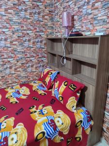 a bedroom with a teddy bear bed and pillows at Tamazart ait melloul in Ait Melloul