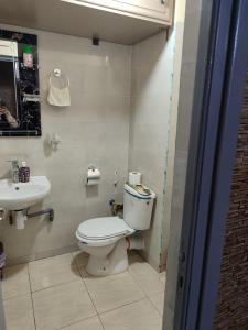 a bathroom with a toilet and a sink at Tamazart ait melloul in Ait Melloul