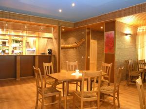 a dining room with a wooden table and chairs at Holiday Complex Šilaičiai in Seirijai