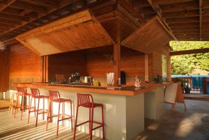 a kitchen with a bar with bar stools at Casa Coral in Luquillo