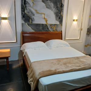 a bedroom with two beds and two lights on the wall at Residence Annapurna Indian in Dakar