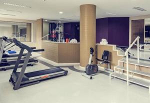a gym with a treadmill and treadles in a room at Prinz Loft in Joinville