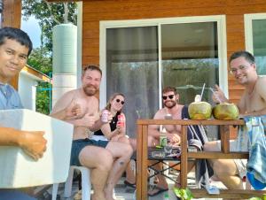 a group of men and women sitting on a porch at Forest Hill Lanta in Ko Lanta