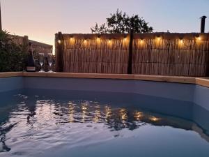 a pool of water with lights on a fence at Entre Espinos in Lo Chaparro