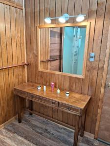 a wooden dressing table with a mirror in a room at Entre Espinos in Lo Chaparro +14 photos