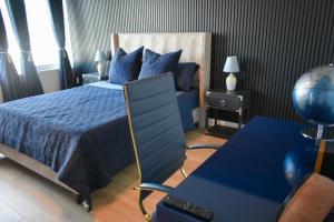 a bedroom with a blue bed and a desk at Willow Estates Harborplace in Baltimore +57 photos
