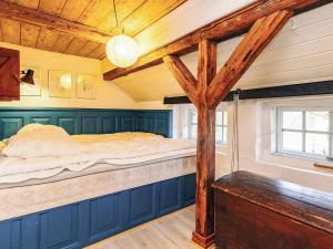 a bed in a room with a wooden ceiling at 4 person holiday home in Asaa in Aså