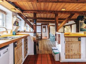 a kitchen with wooden ceilings and a wooden floor at 4 person holiday home in Asaa in Aså