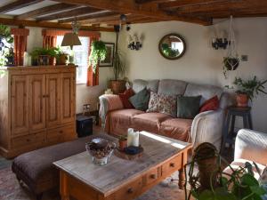 a living room with a couch and a coffee table at Hill House in Colchester