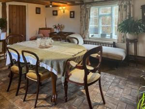 a dining room with a table and chairs at Hill House in Colchester