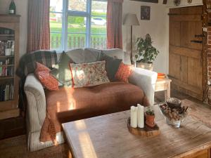 a living room with a couch and a coffee table at Hill House in Colchester +17 photos