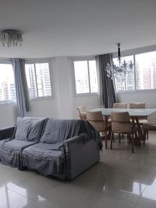 a living room with a bed and a table and chairs at Sonatta in Torres