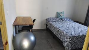 a room with a bed and a table and a tableablish at Villa Carpintera in Puntarenas