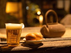 a glass of water and a bowl of eggs on a table at Wa no Yado Sagiritei in Yufu