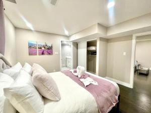 a bedroom with a large white bed with white pillows at Violet Escape Modern Apt 1B 1B, Kitchen, Parking in Richmond Hill
