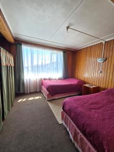 a hotel room with two beds and a window at Hotel Bahia in Quellón +22 photos