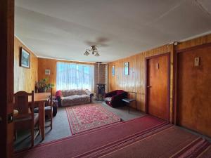 a living room with a table and a dining room at Hotel Bahia in Quellón