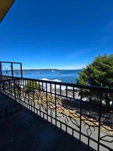 a balcony with a view of the water at Hotel Bahia in Quellón