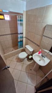 a bathroom with a toilet and a sink at Mirador Backpackers B&B in Huaraz +42 photos